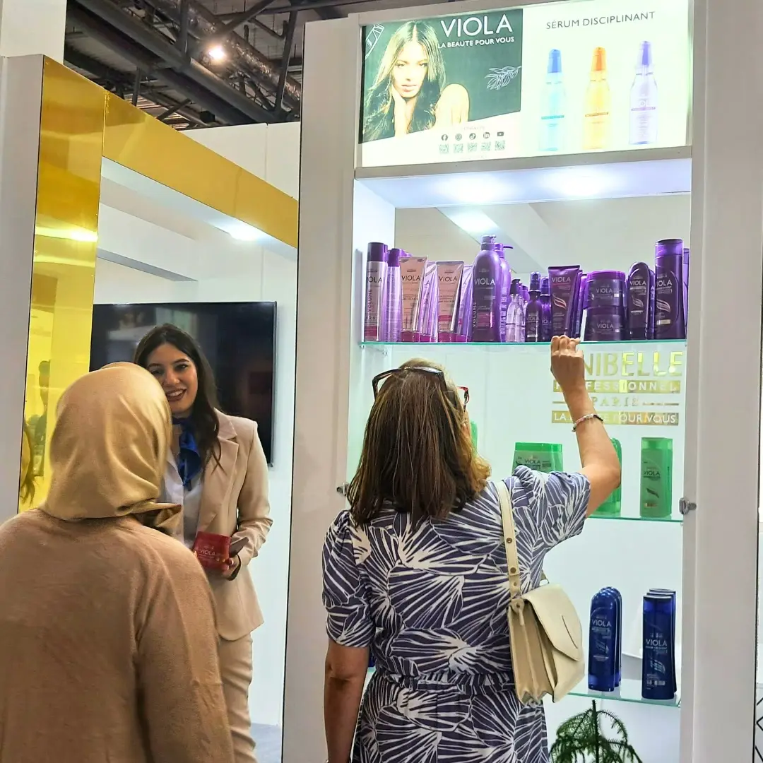 Visitors at an exhibitor's hair care shelves