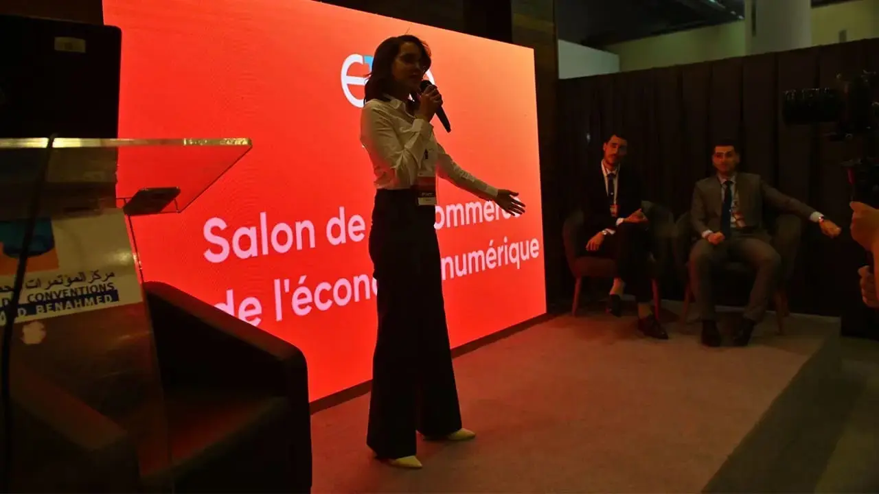 A speaker on stage at ECO Oran 2024, the show's pilot edition in Oran