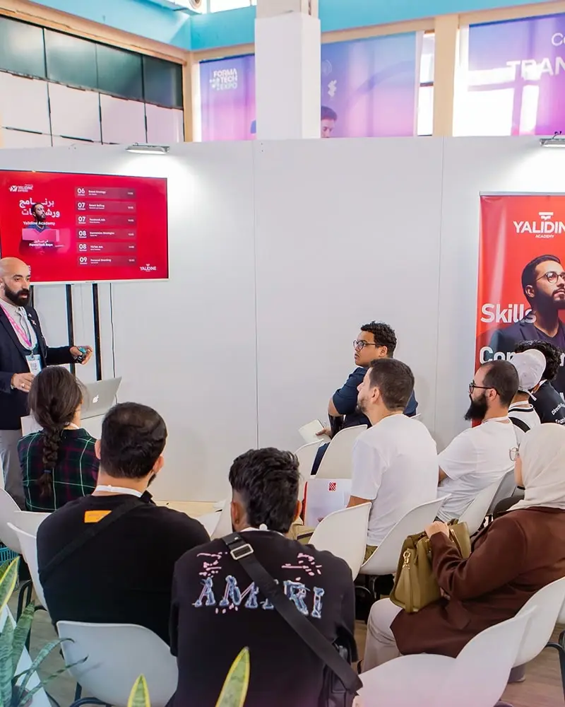 A workshop on a stand, in front of seated visitors