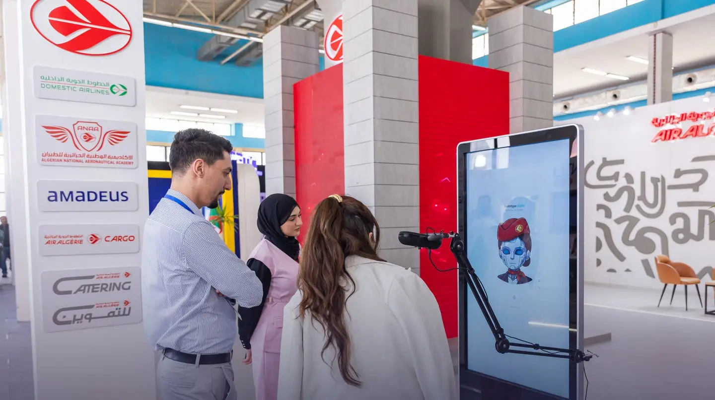 Visitors trying an interactive screen demonstrated on a stand